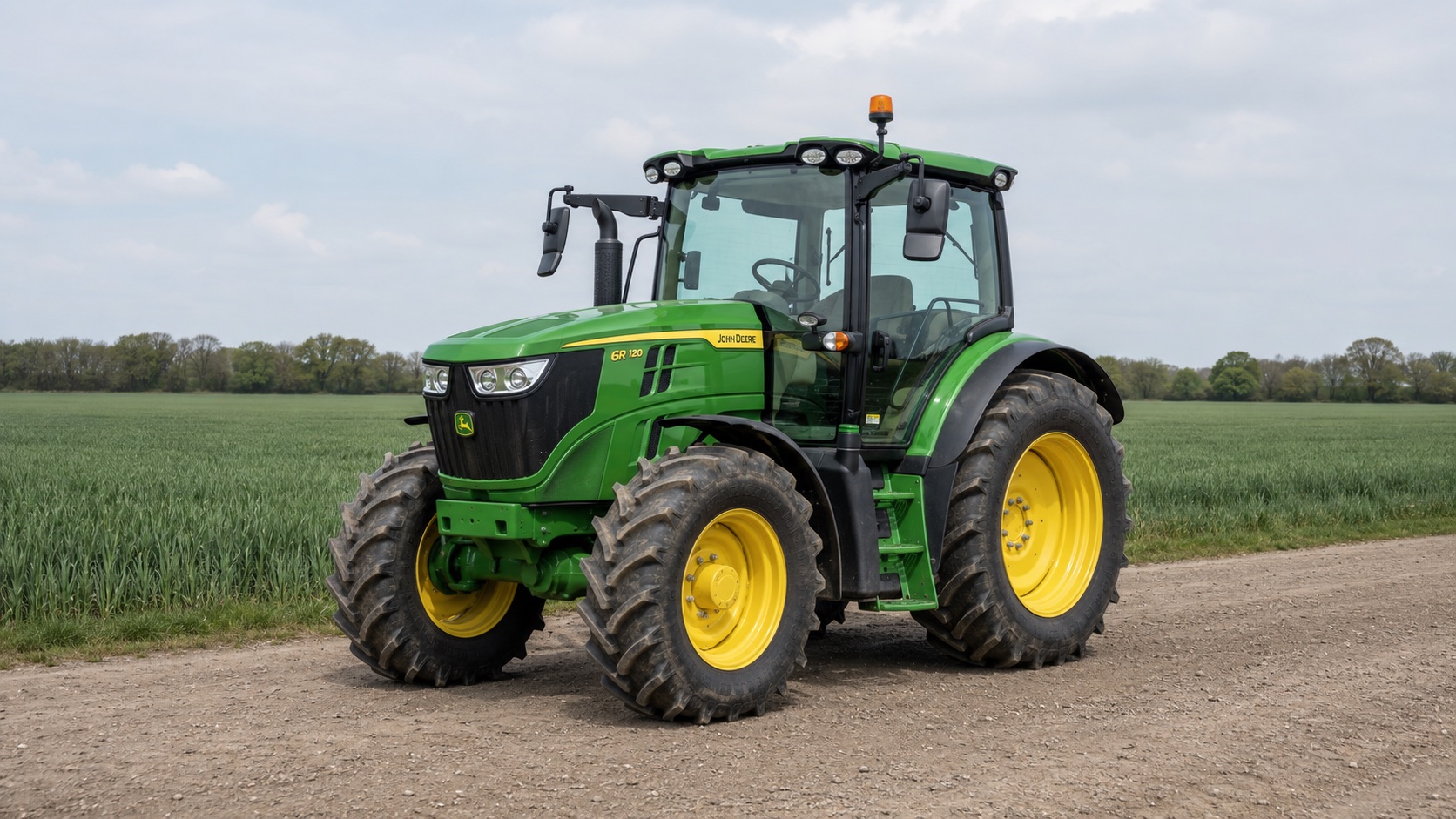Tracteur John Deere 6R 120 présenté dans un environnement agricole